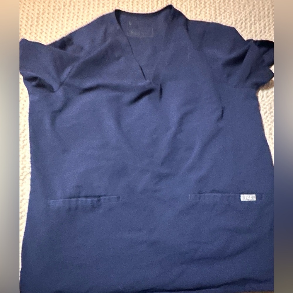 Figs scrub top with pockets.  This price includes 2 tops when purchased